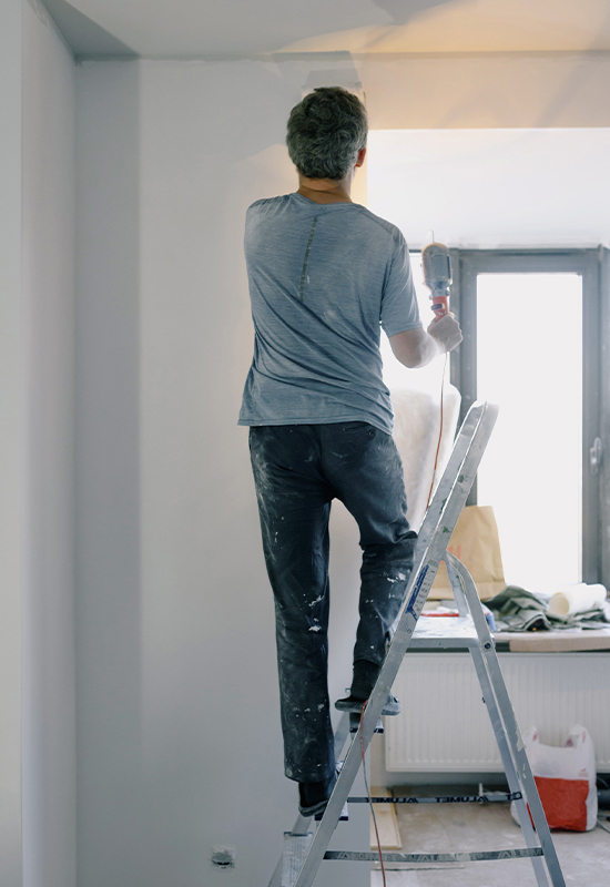 DIYlead Man on ladder painting wall