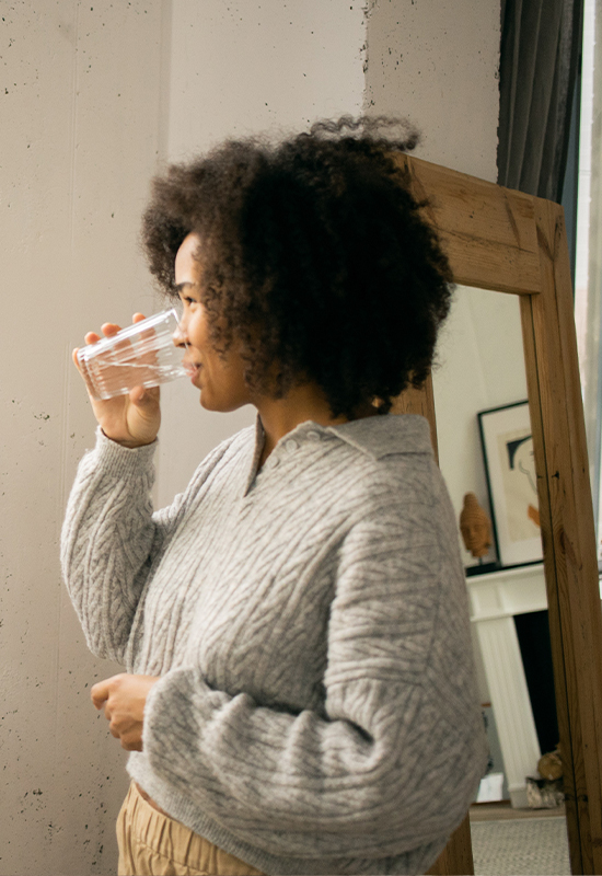 Woman drinking water and smiling