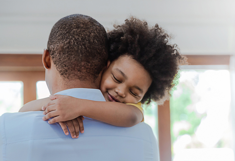 Girl in the arms of her father