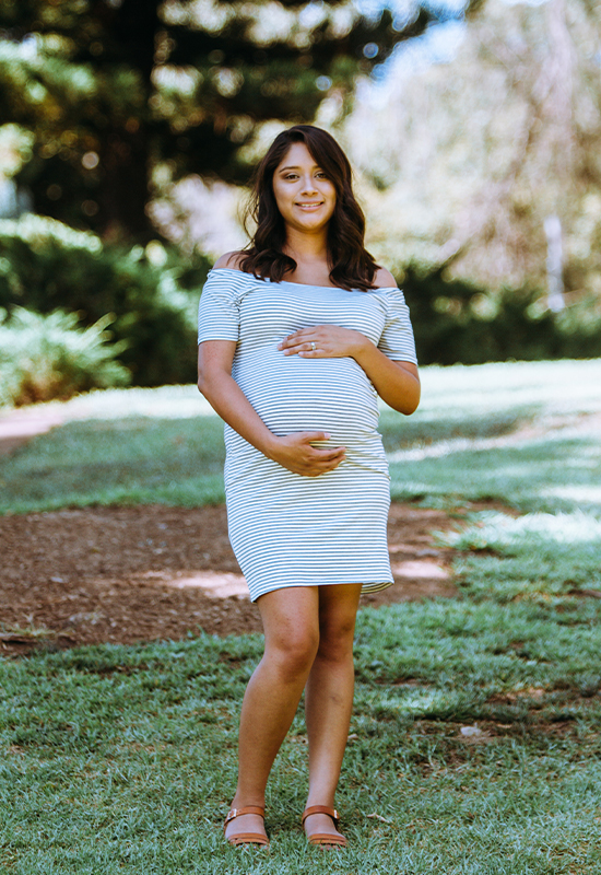 Pregnant Hispanic woman posing for picture